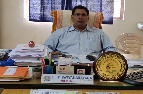 Dr. T. Satyanarayana, Principal, at his desk